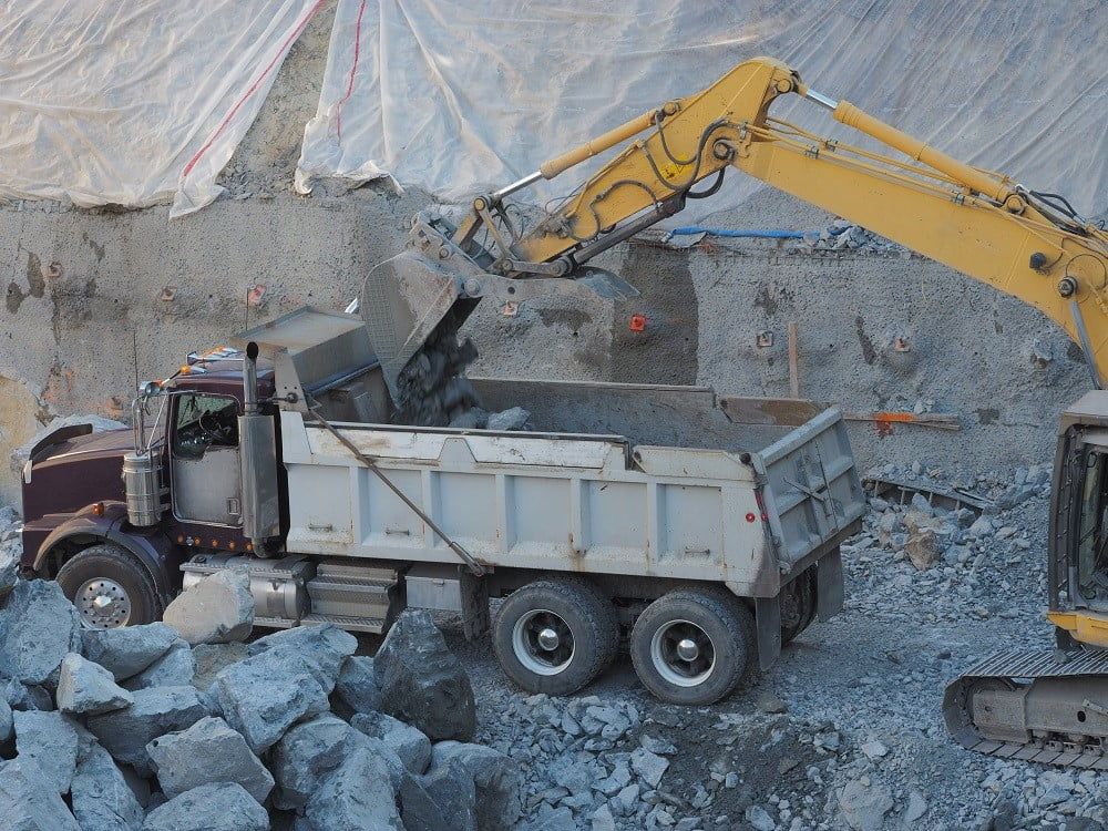 A man is leveling a concrete floor with a level.
