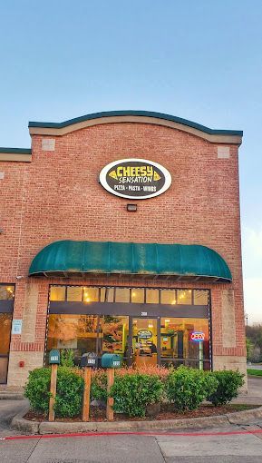 The front of a brick building with a green awning.