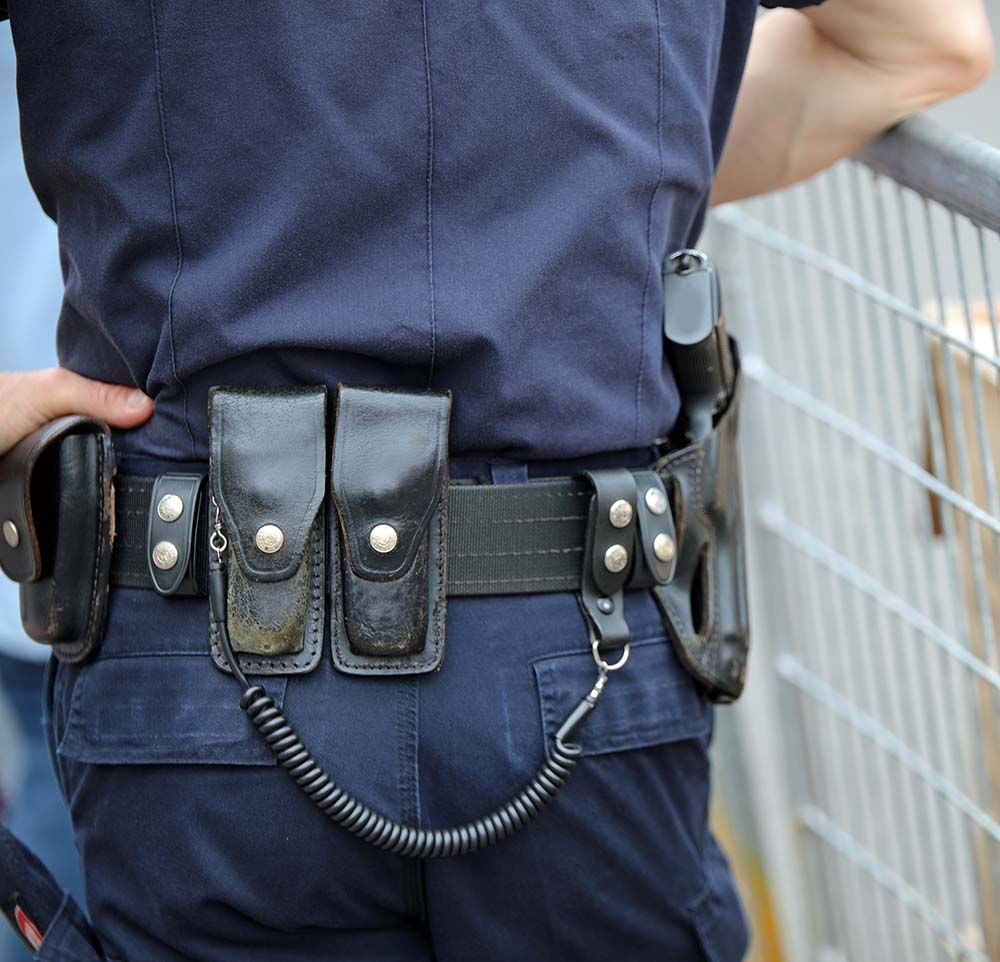 The back of a police officer wearing a black belt
