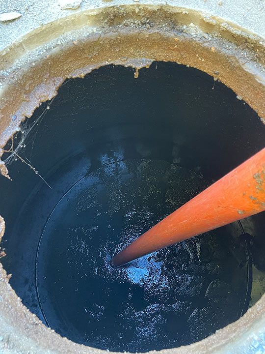 A Manhole Cover With A Pipe Sticking Out Of It — Mackay Septic Pumping In Moranbah, QLD