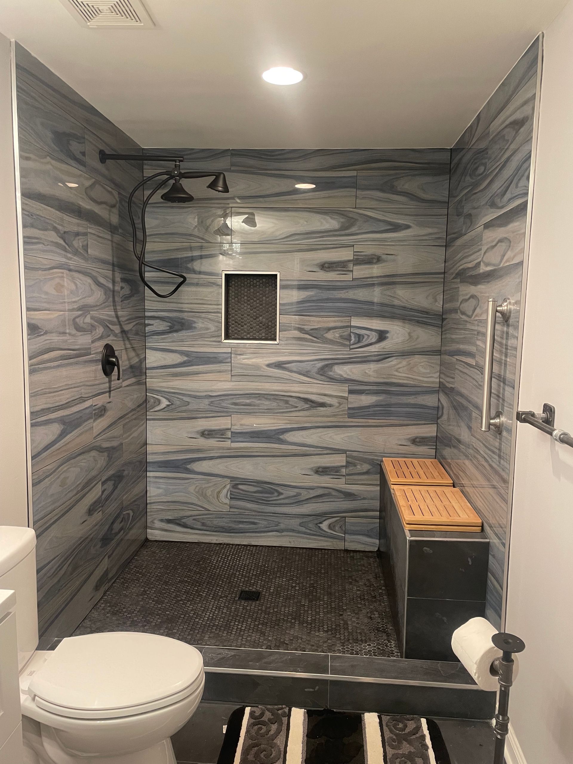 Bathroom with a clawfoot tub, gray walls, a decorative chandelier, and a small shelf with candles and greenery. Bathroom with a clawfoot tub, gray walls, a decorative chandelier, and a small shelf with candles and greenery.