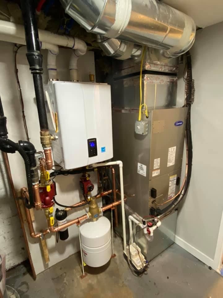 A room with a lot of pipes and a heater.