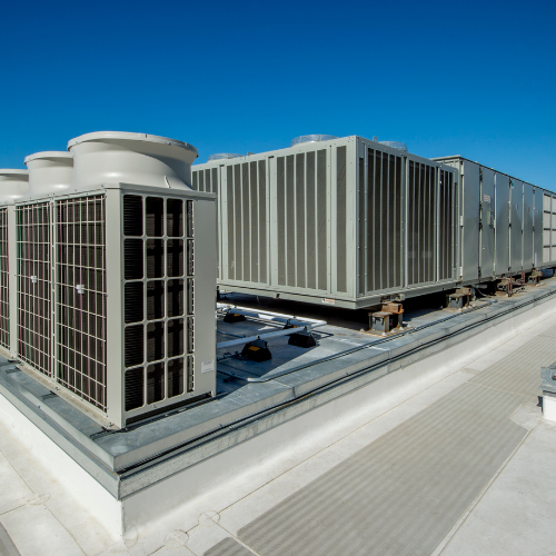 A rooftop with a lot of air conditioners on it