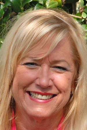 A close up of a woman 's face smiling.