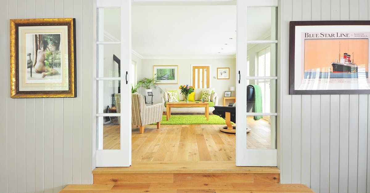 A living room with hardwood floors and sliding glass doors leading to a dining room.
