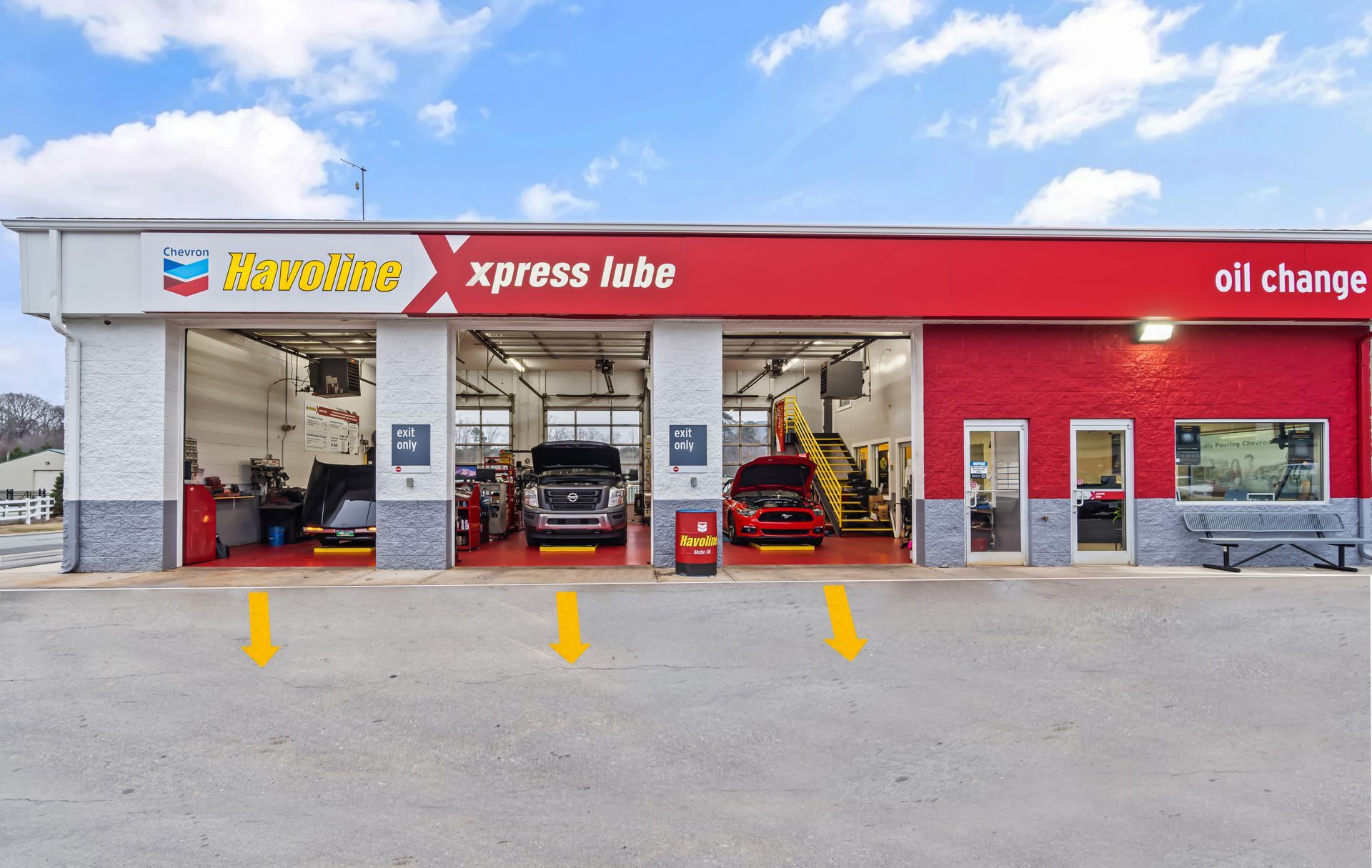 Xpress Lube oil change shop with cars in service bays and a red storefront