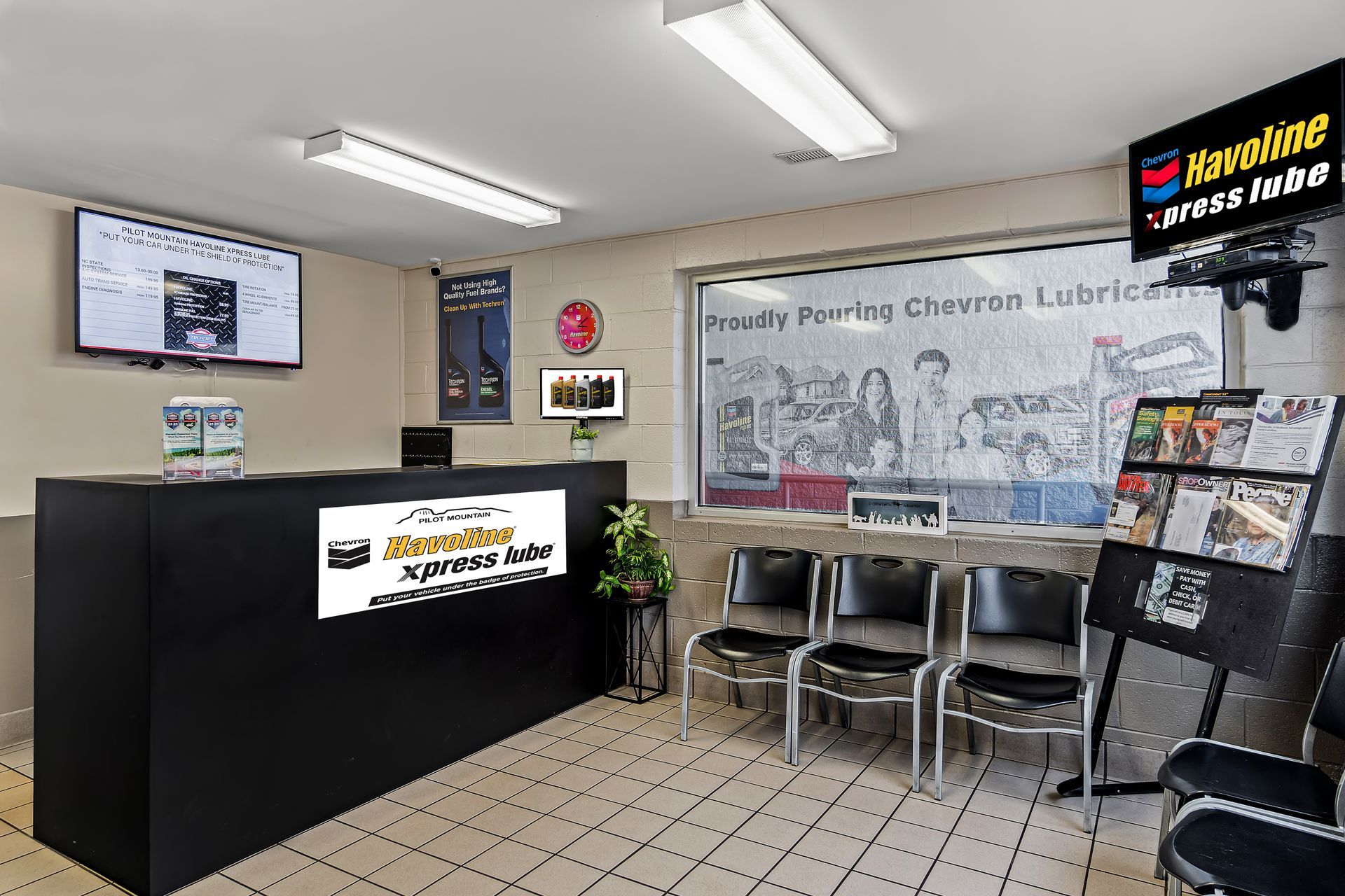 Library lobby with black counter, chairs, and a sign for “Library Printing and Copying.”