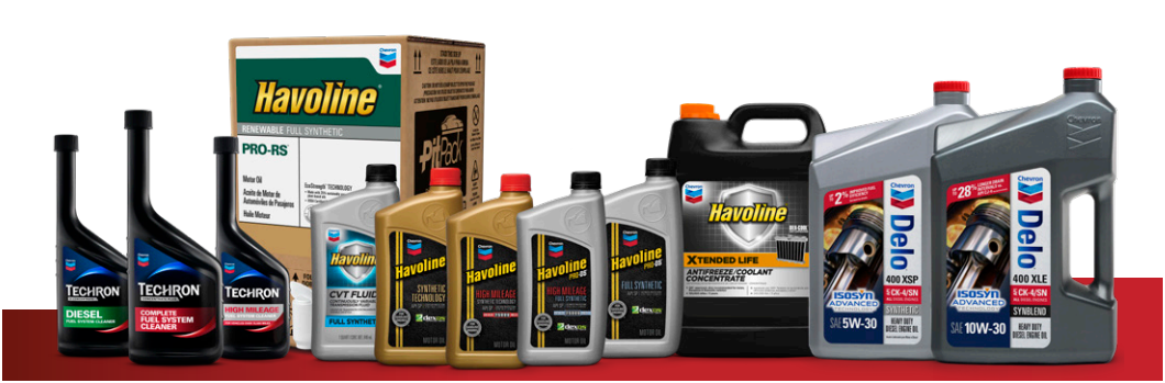 Assorted automotive fluids and lubricants displayed in product bottles and boxes on a white background