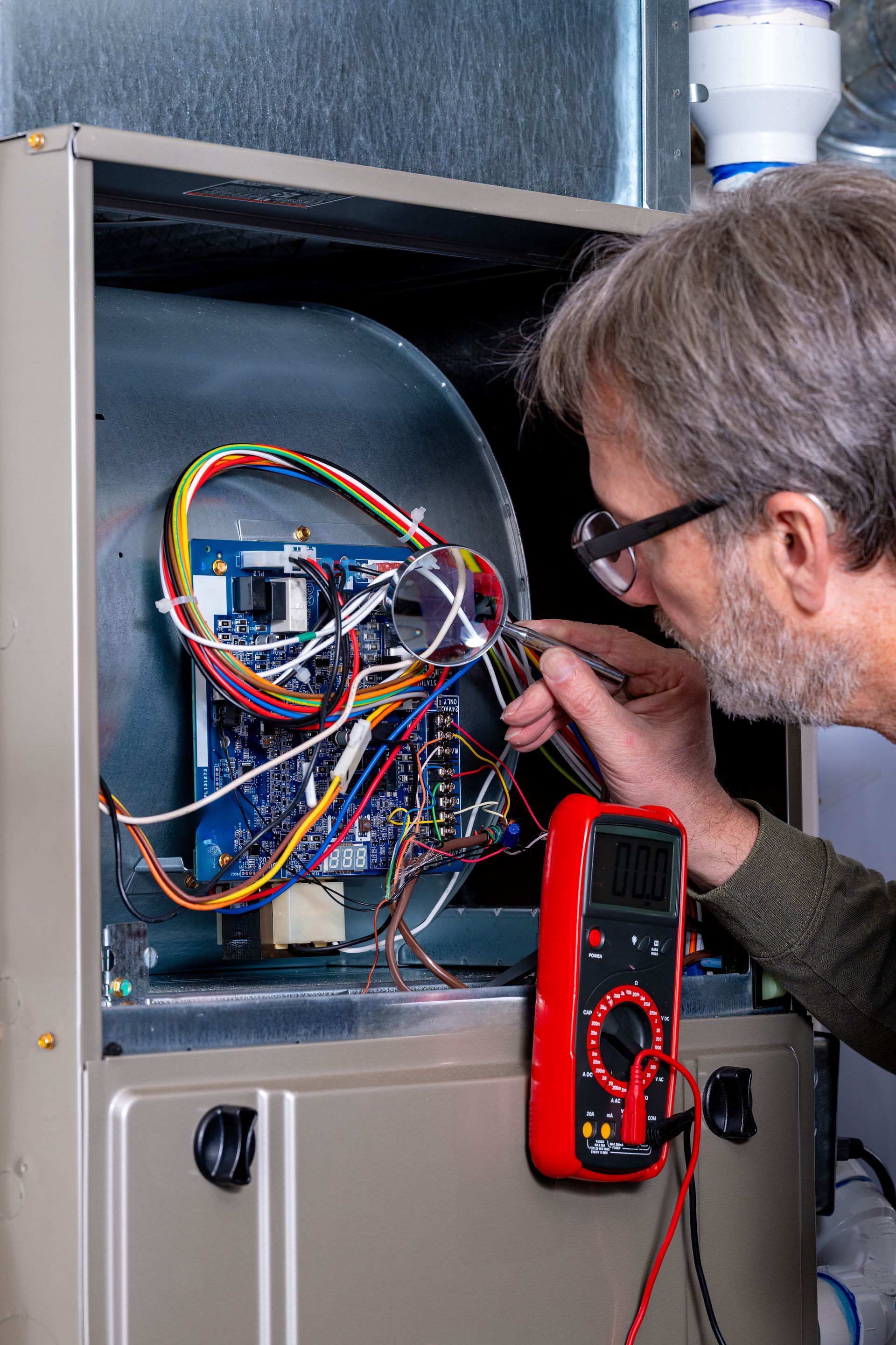 HVAC technician repairing a furnace in St. Clair Shores