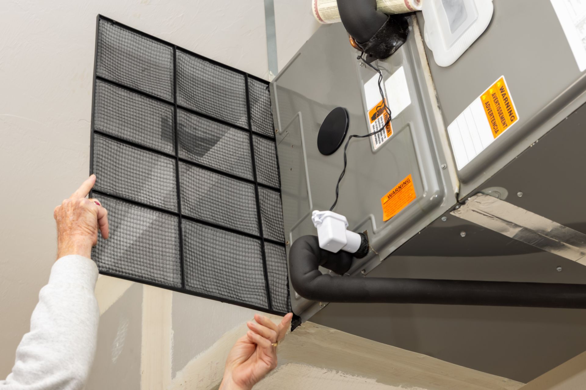 HVAC technician repairing a furnace in Mt. Clemens