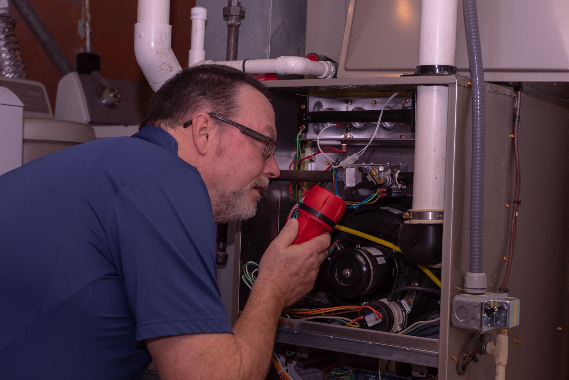 Licensed Heaney technician reviewing furnace repair work with a Clinton Township customer