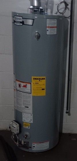 Plumber checking a water heater temperature gauge