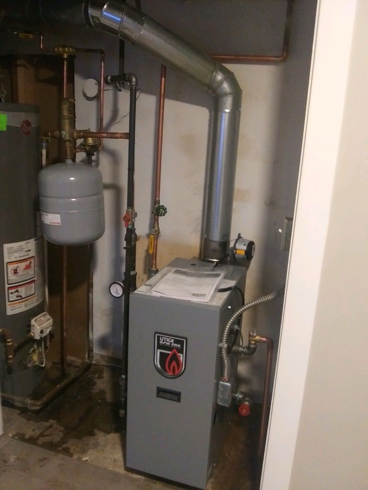 Technician completing a furnace installation in a residential utility room