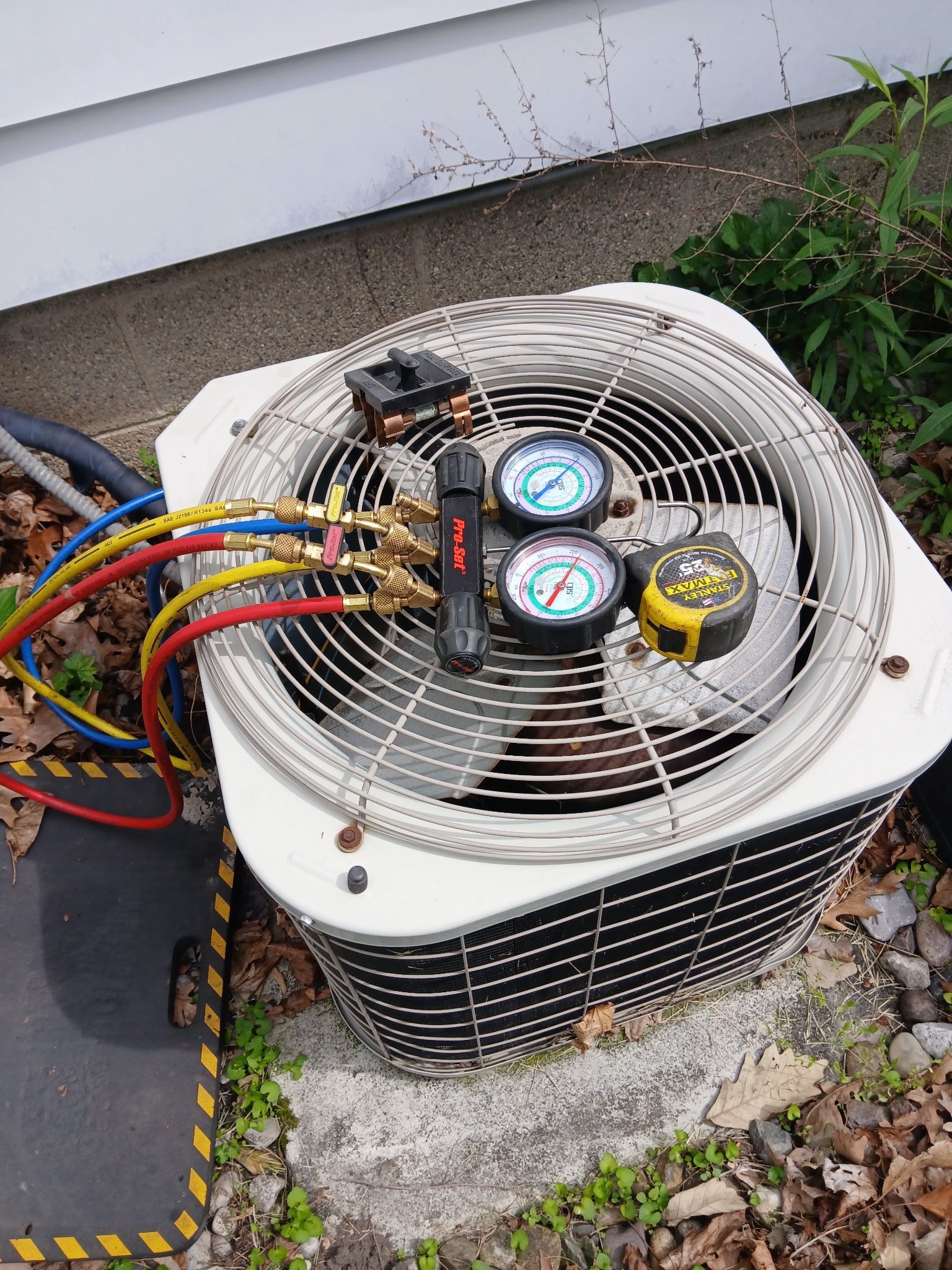 Heaney technician diagnosing an air conditioning unit malfunction in Macomb County.