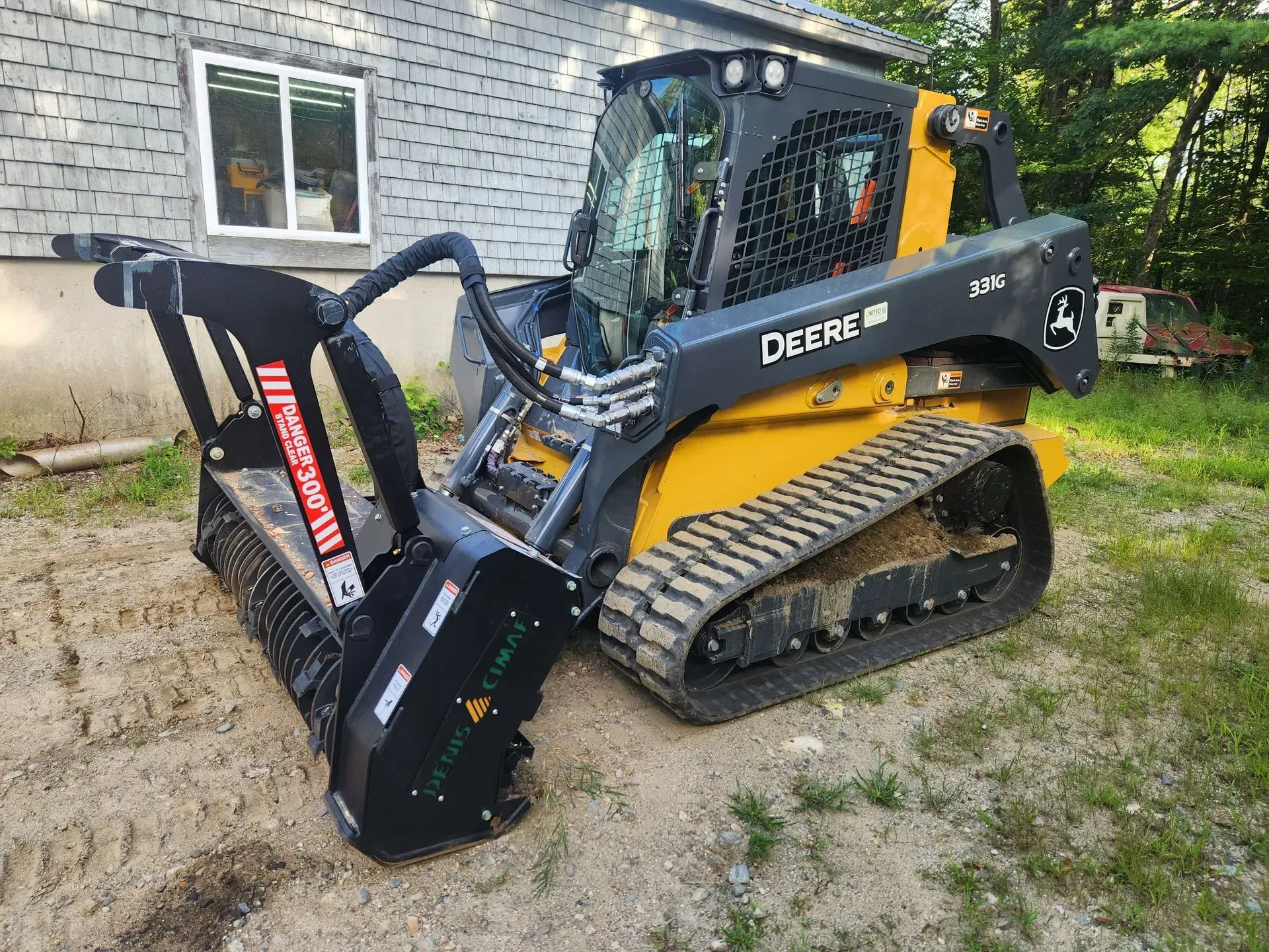 A deere tractor is parked in front of a house.