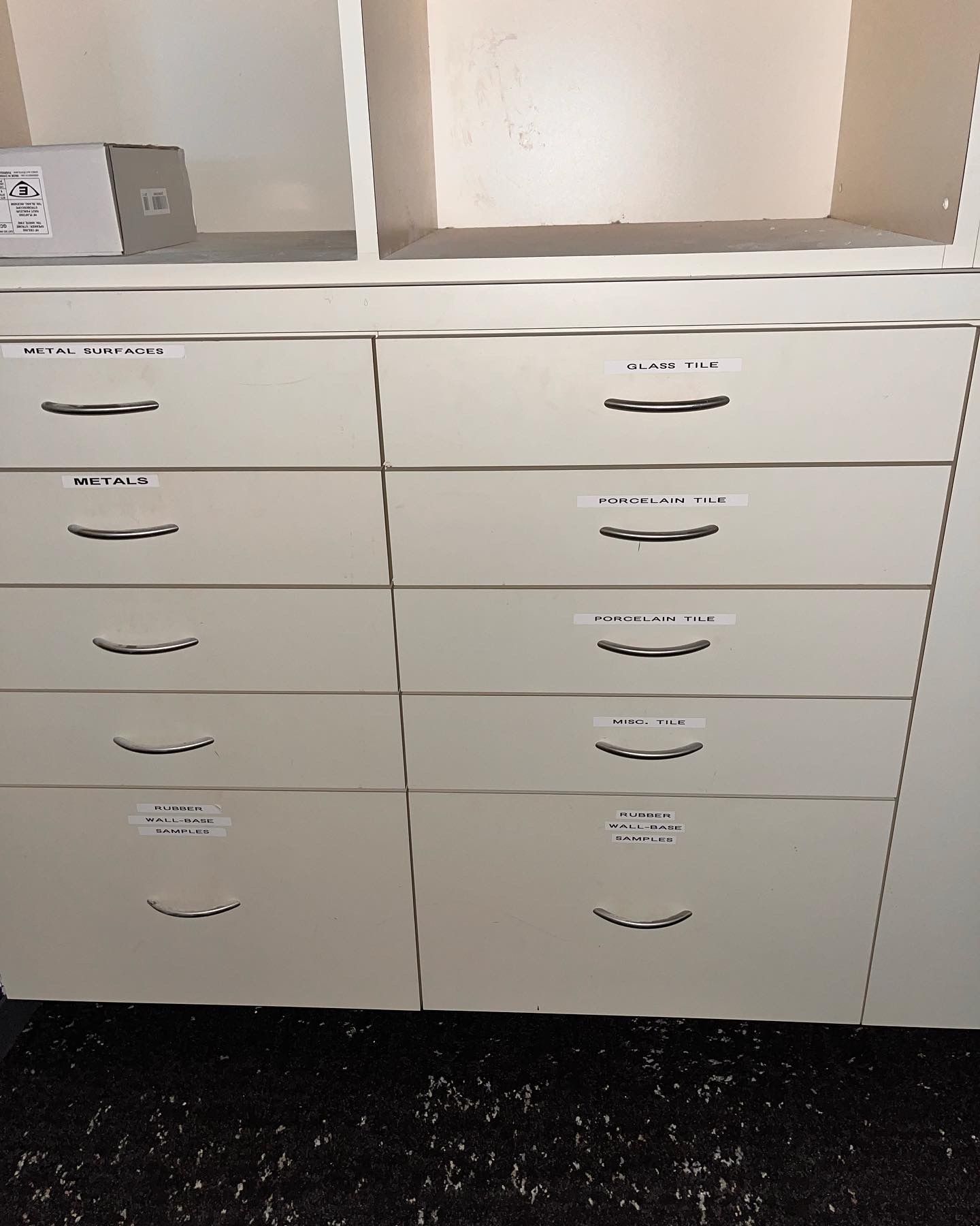 A row of white drawers are lined up in a row