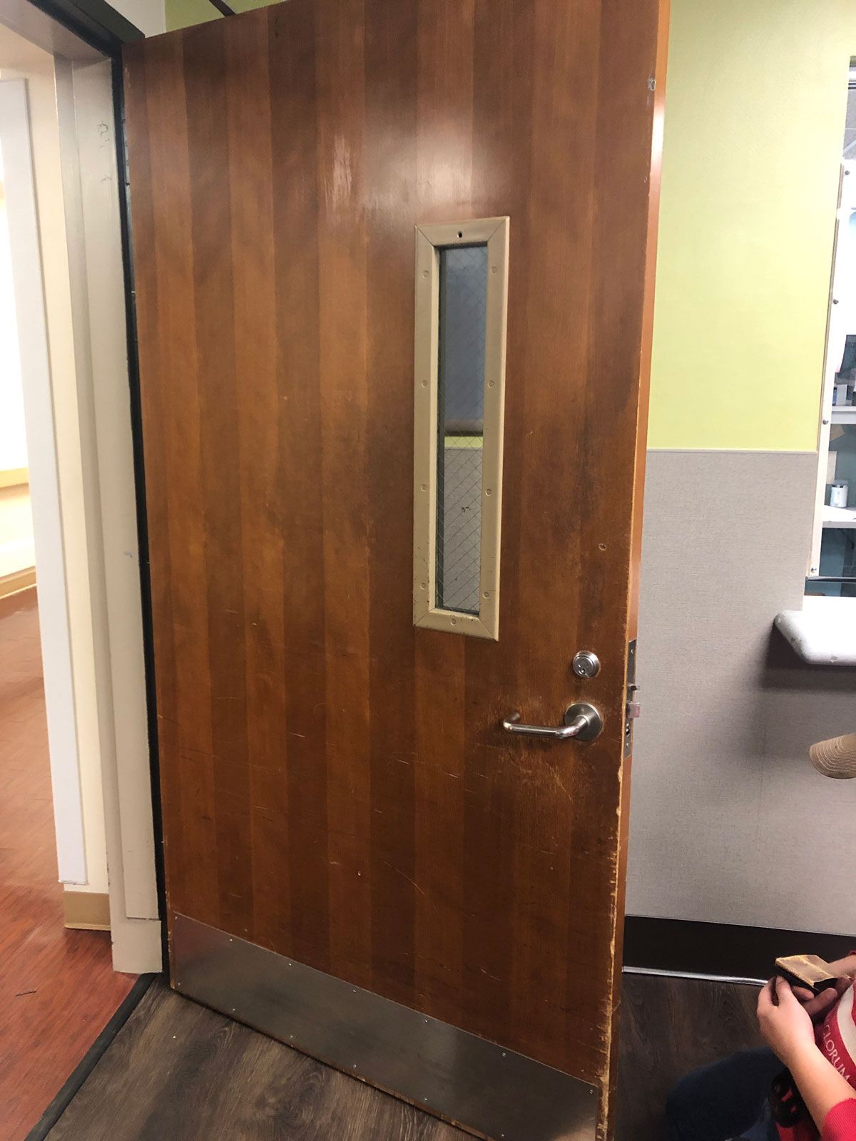 A wooden door with a small window on it