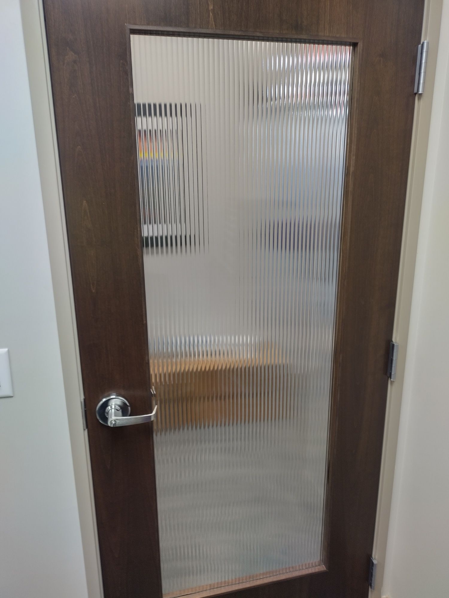 Wooden office door with textured glass panel and silver handle