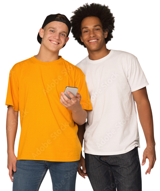 Two young men smiling, one holding a phone, both wearing t-shirts and jeans against a white background.