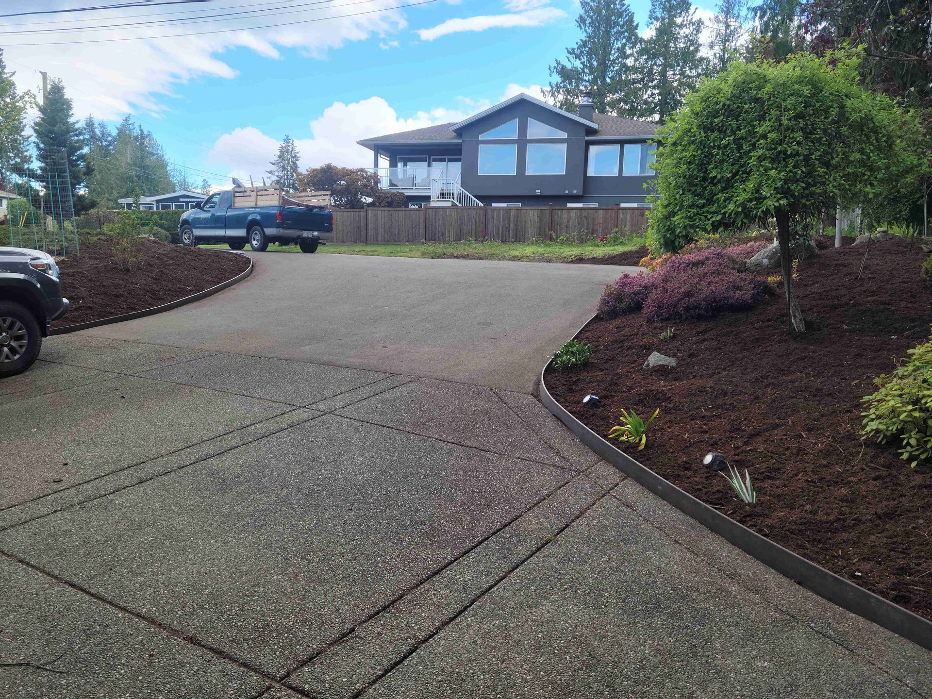 A truck is parked in the driveway of a house