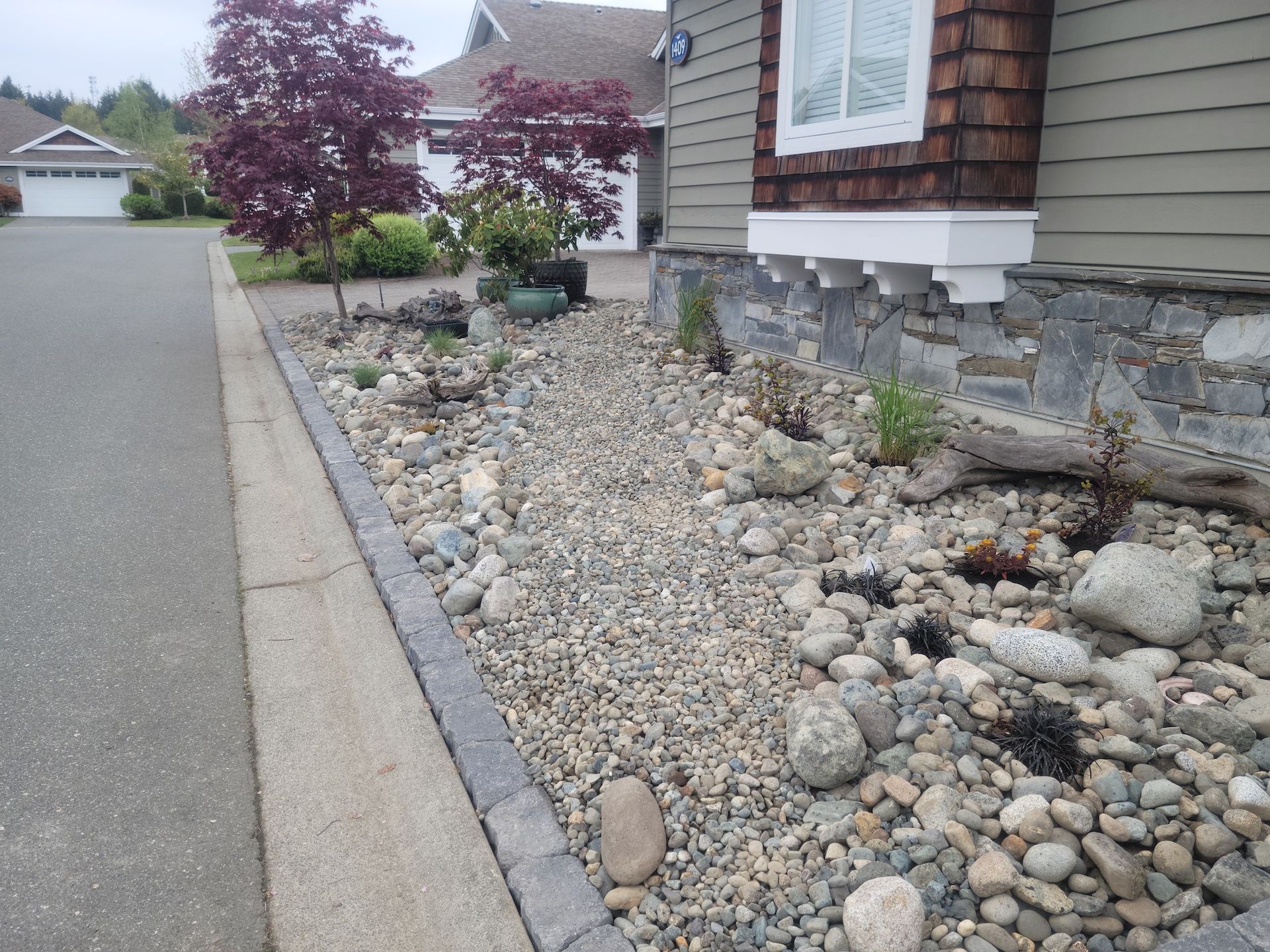 A house with a lot of rocks in front of it