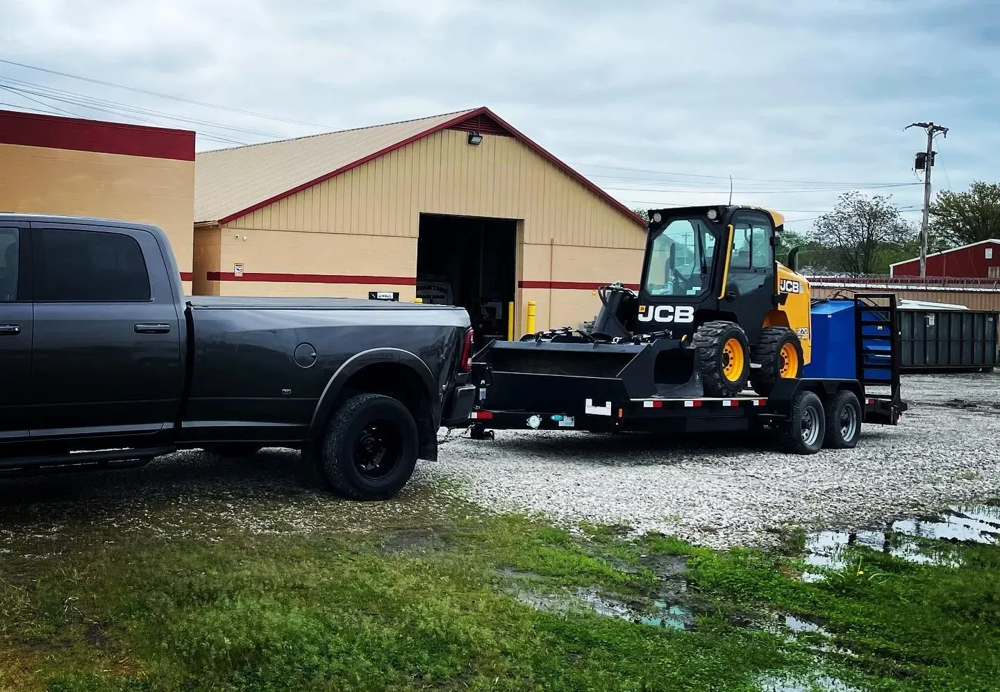 A truck is towing a bulldozer on a trailer.