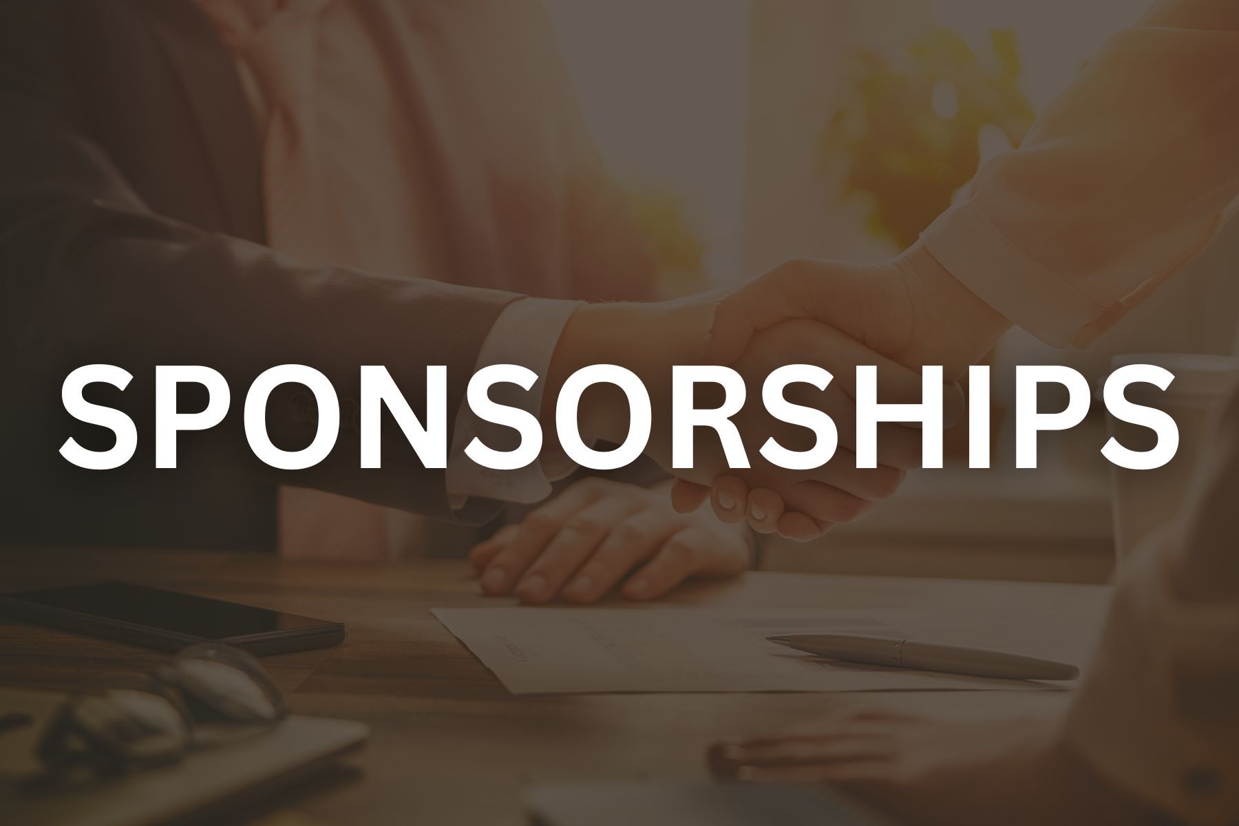 Photo of two handshaking with black overlay that reads sponsorships