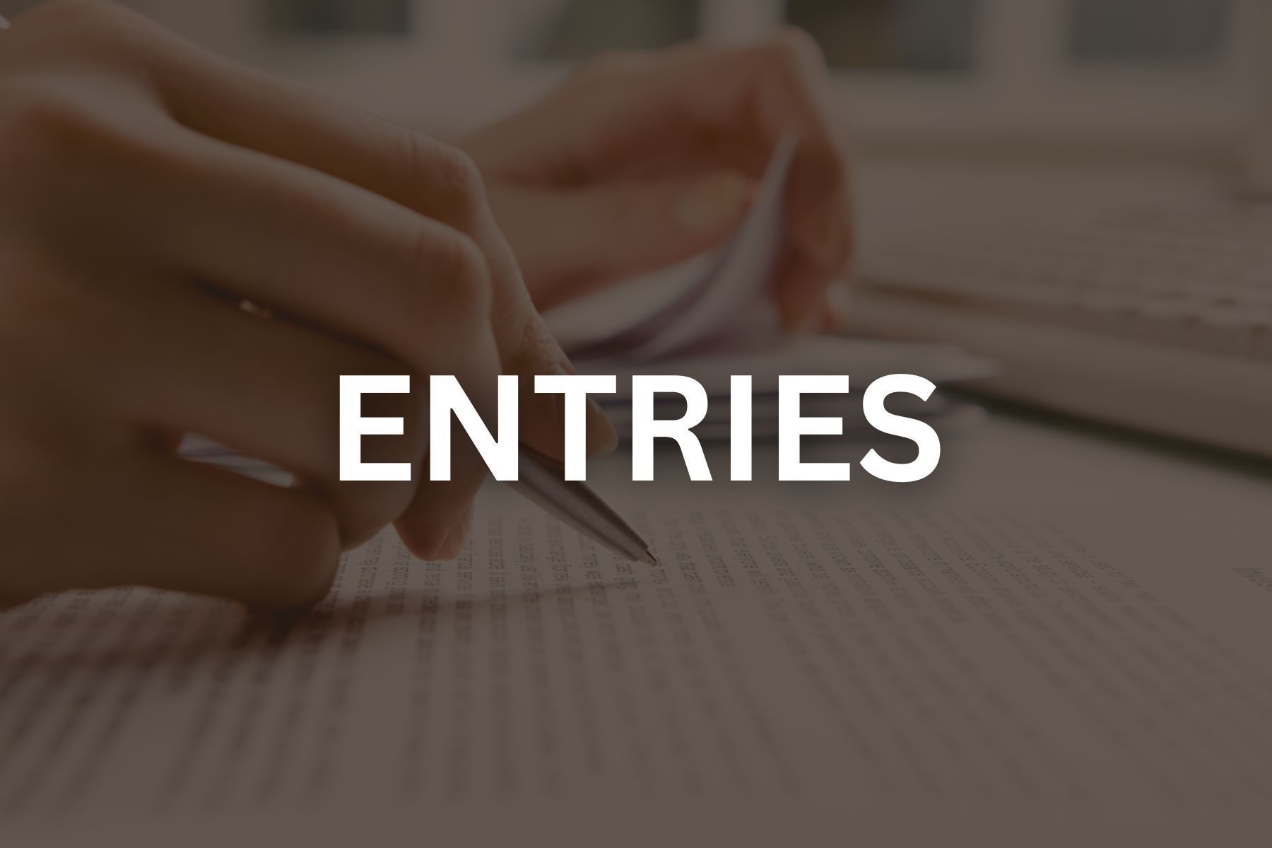 Photo of someone writing with black overlay that reads entries