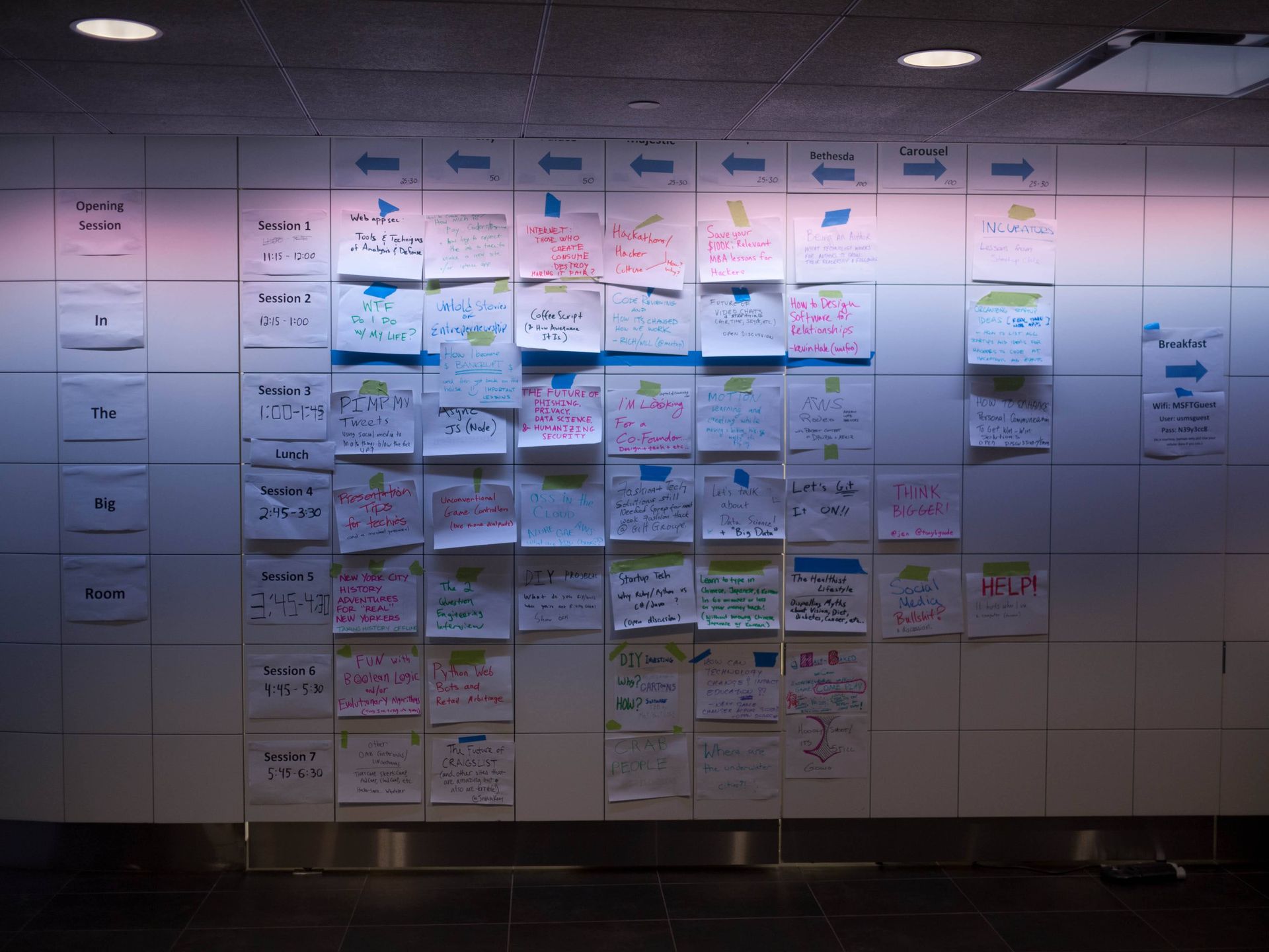 An unconference planning grid, with ad-hoc proposals taped to the wall