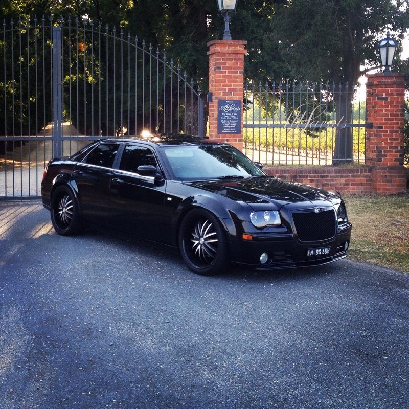 Black Chrysler 300 Sedan Parked in Front of Ornate Iron Gates — Cartech Australia in Albury, NSW