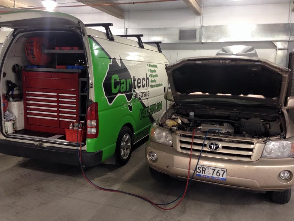 A Beige Car Connected to A Mobile Repair Van with Tools — Cartech Australia in Albury, NSW
