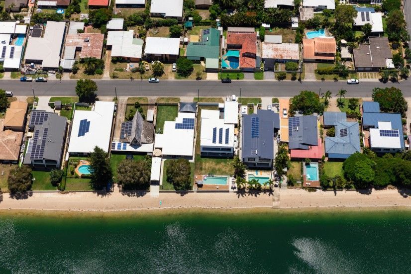 Aerial View of Houses Along a Waterfront Street with Pools — Cartech Australia in Howlong, NSW