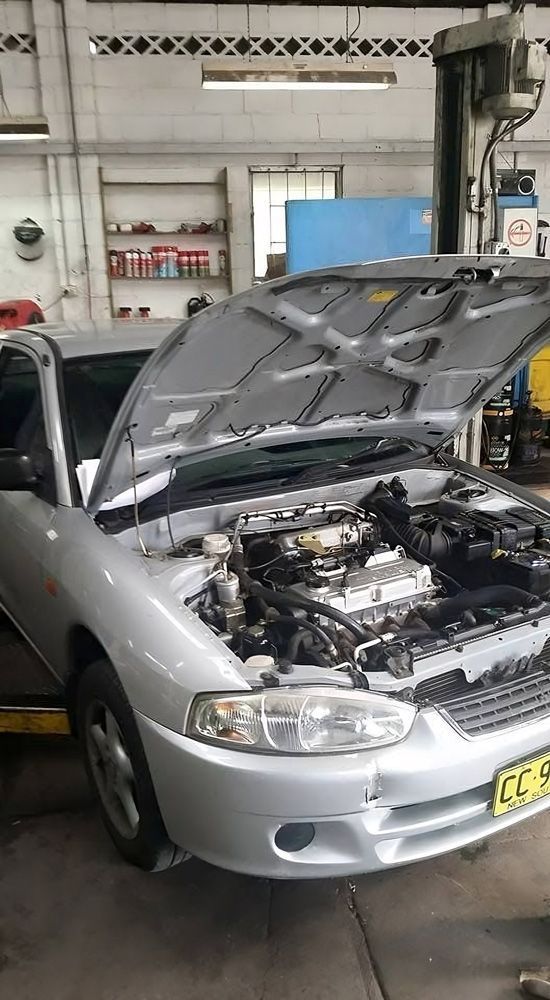 Car with An Open Hood in A Garage for Servicing