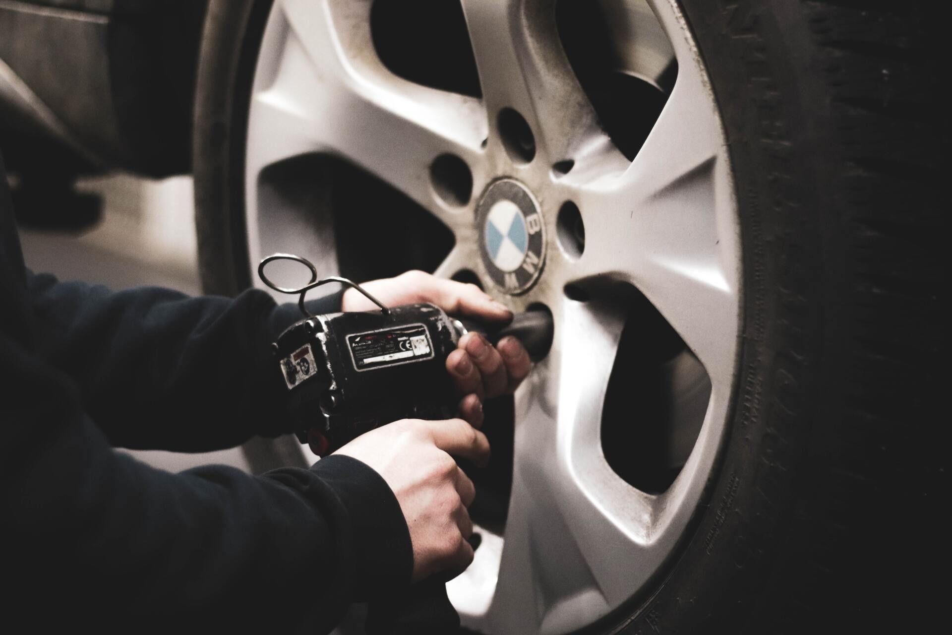 A Person Using a Power Tool to Remove a Lug Nut — Cartech Australia in Albury, NSW
