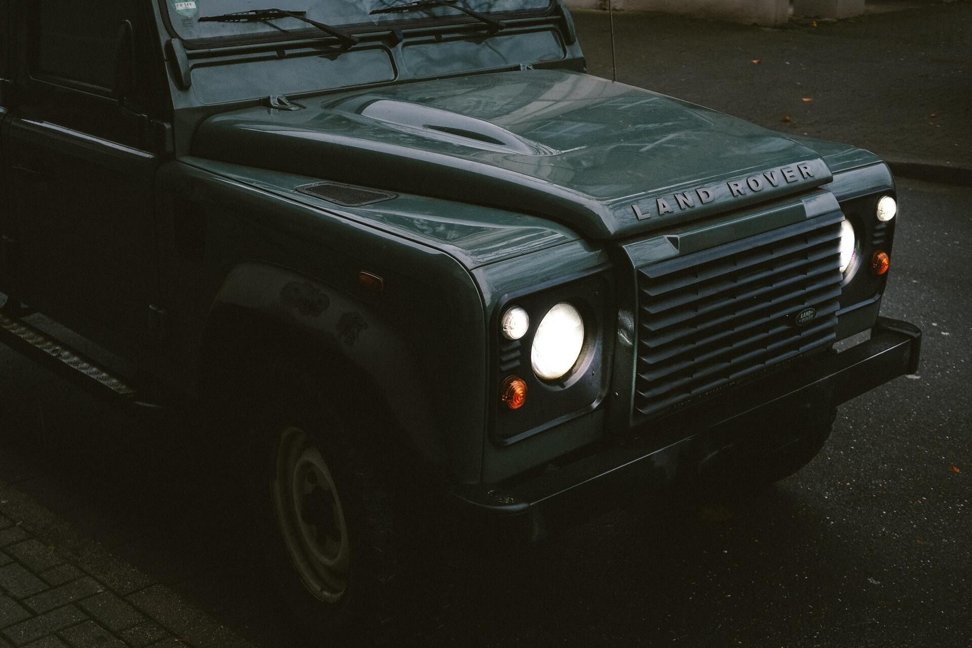 Dark Green Land Rover Defender with Headlights On — Cartech Australia in Lavington, NSW