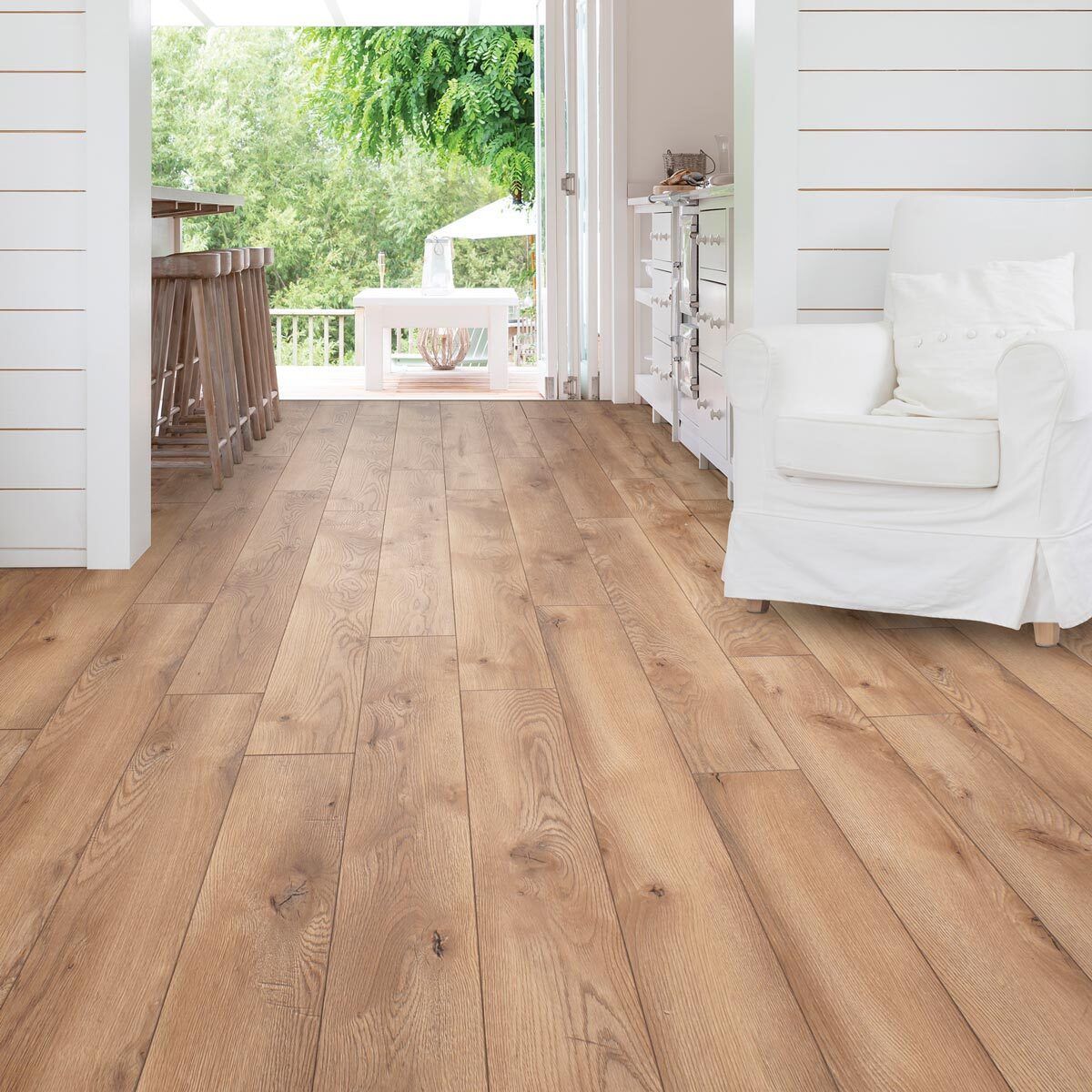 A living room with hardwood floors and a white chair