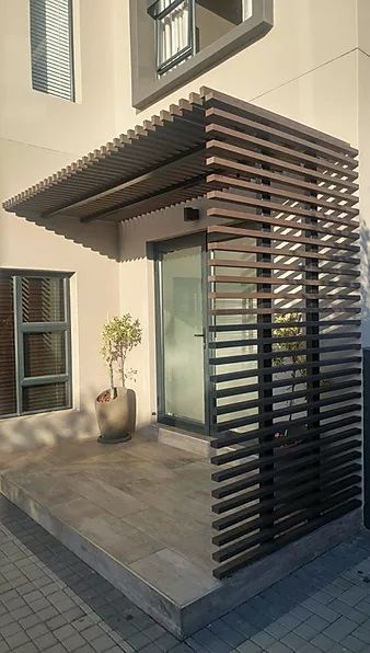 A building with a wooden fence around it and a sliding glass door.