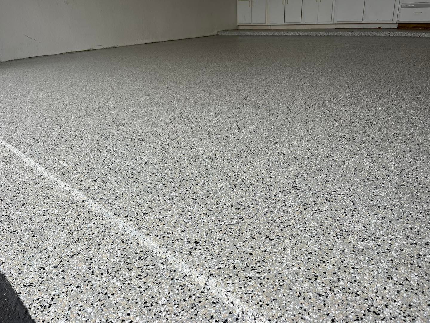 Grey speckled epoxy garage floor.