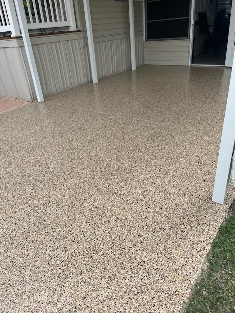 A covered patio with a speckled epoxy floor.