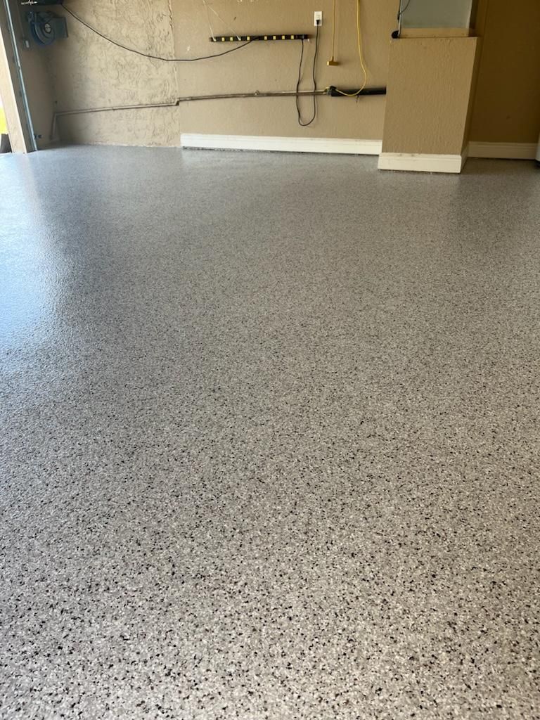 Gray epoxy-coated garage floor with speckled aggregate.