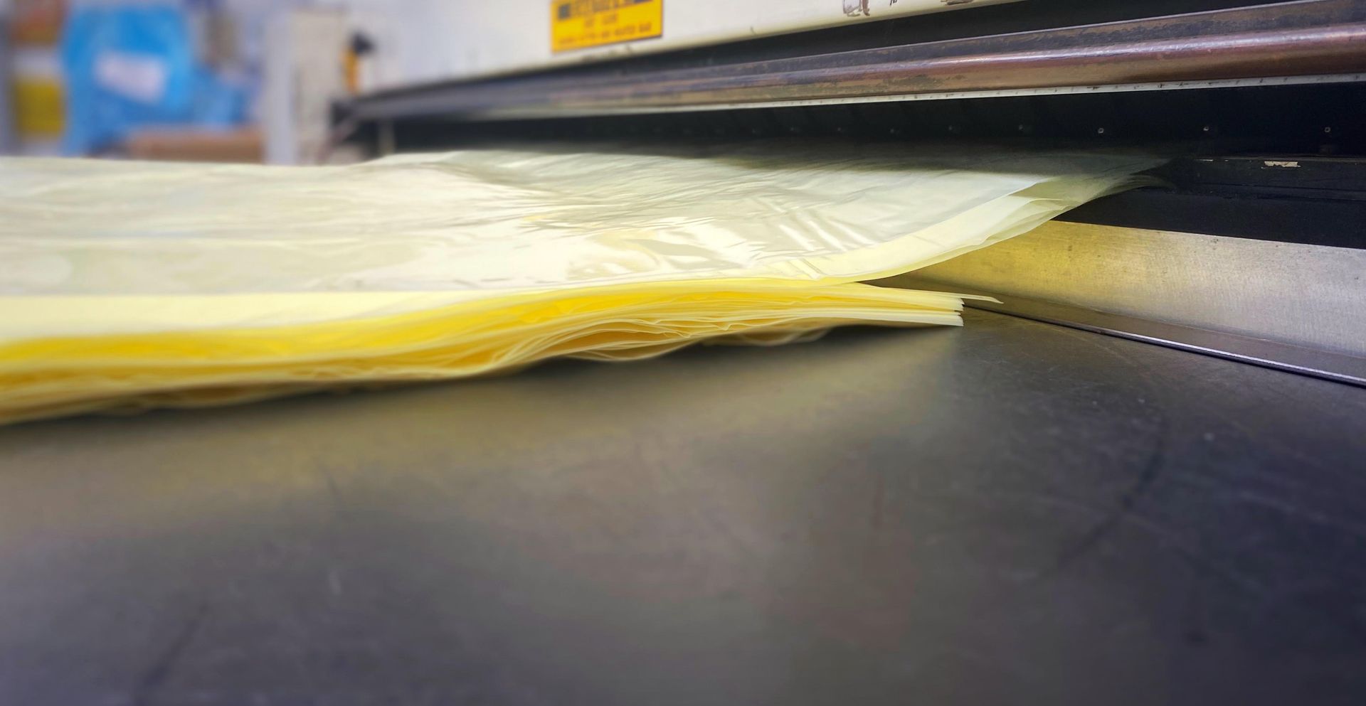 A piece of plastic is being cut by a machine.