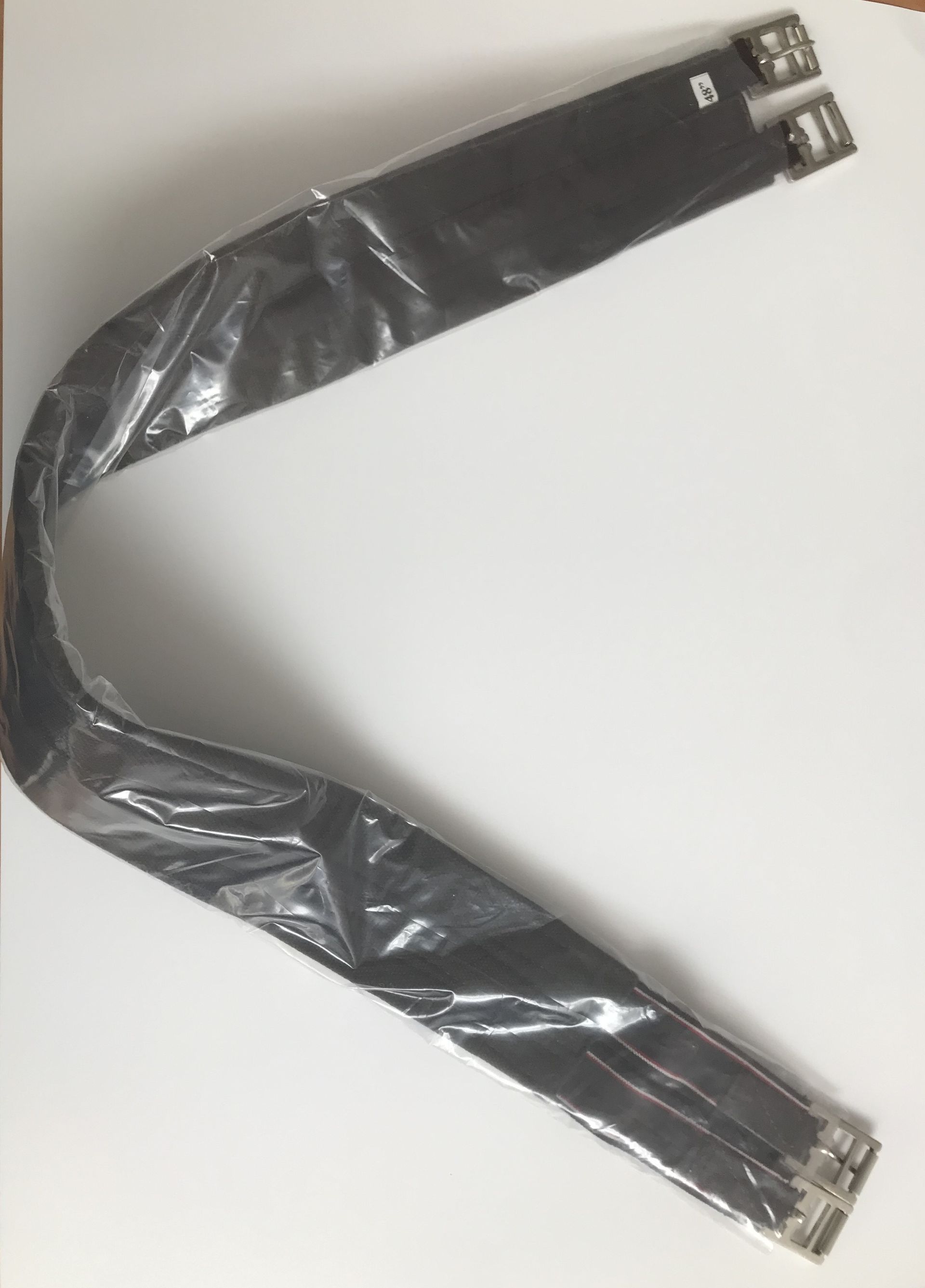 A bag of food is being poured into a stainless steel pan