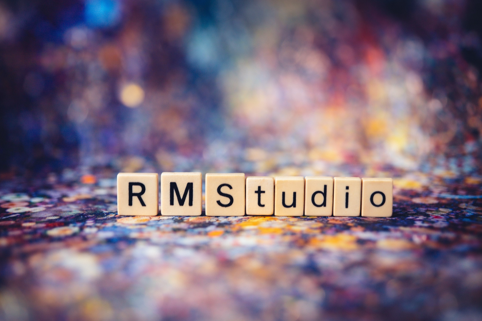 Scrabble tiles on a blurred, colorful, bokeh background spell out