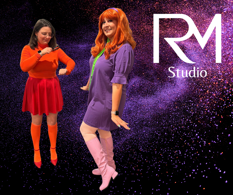 Two people dressed as Daphne and Velma from Scooby-Doo stand against a purple, sparkling background with RM Studio branding.