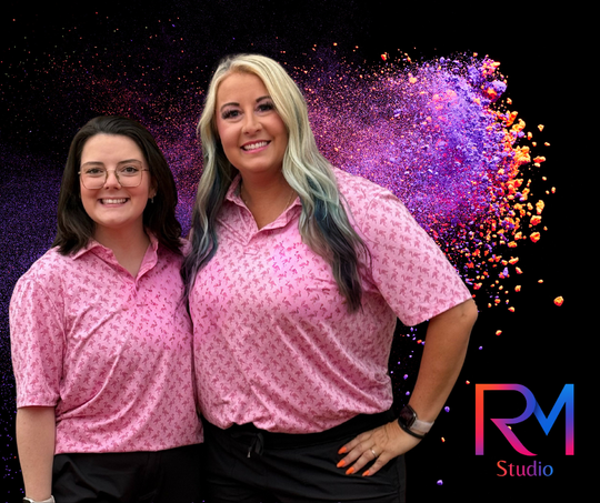 RM Studio wearing matching pink patterned polo shirts and black pants against a black background with purple powder art.