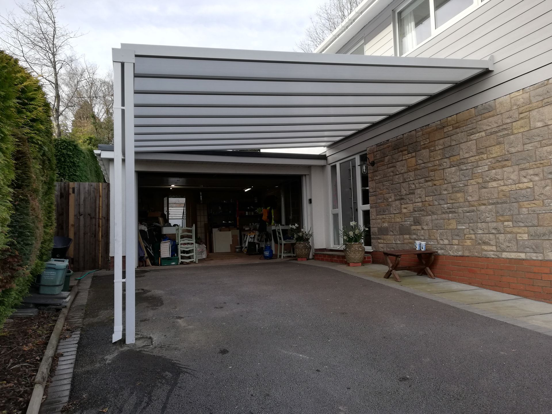 A carport is attached to the side of a house.
