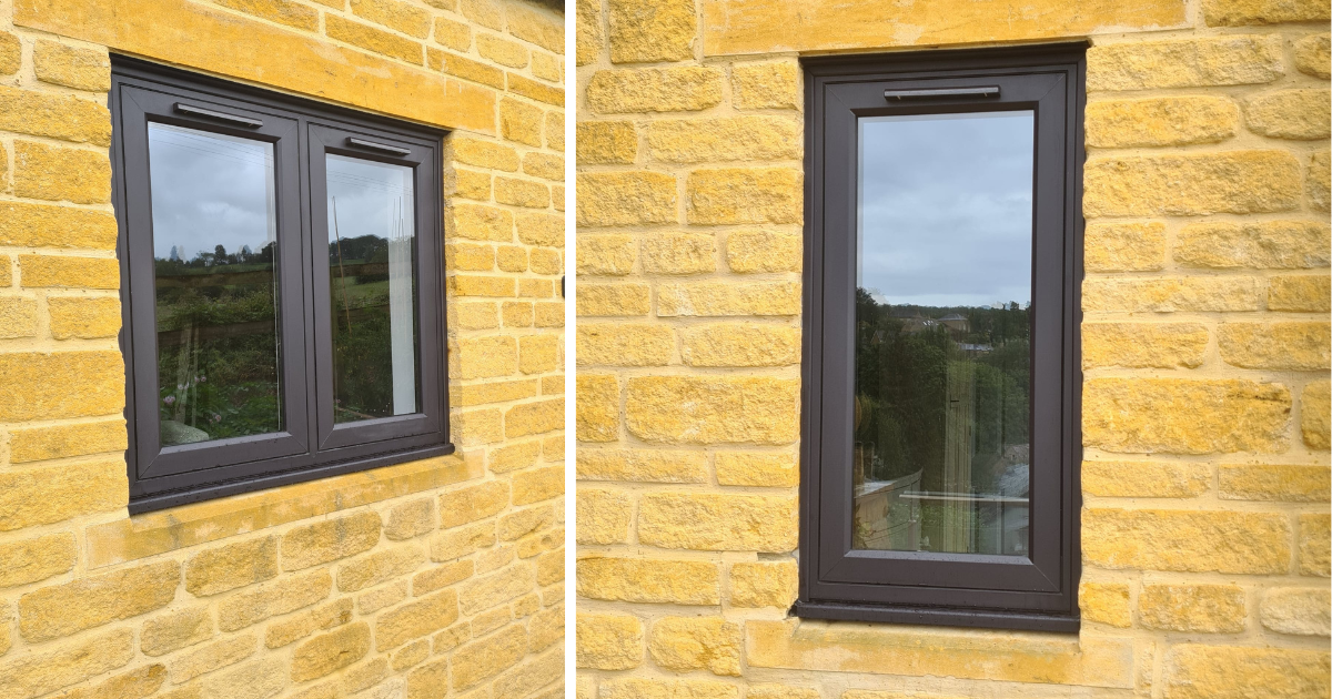 Two black/brown-uPVC framed windows set in a yellow brick wall, one wide and one narrow.