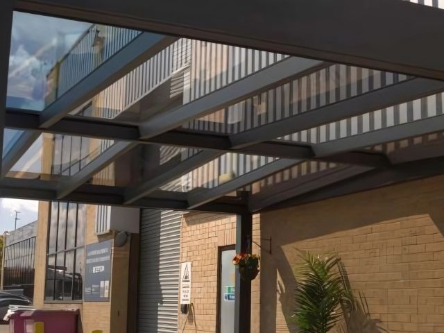 A building with a glass roof and a brick wall.
