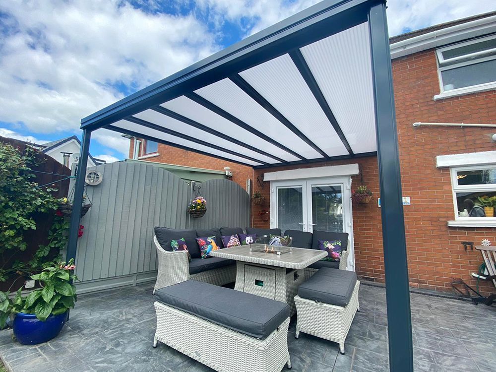 A patio with a table and chairs under a canopy.