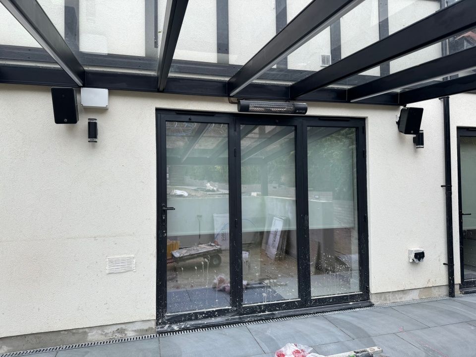 A house with a glass roof and sliding glass doors